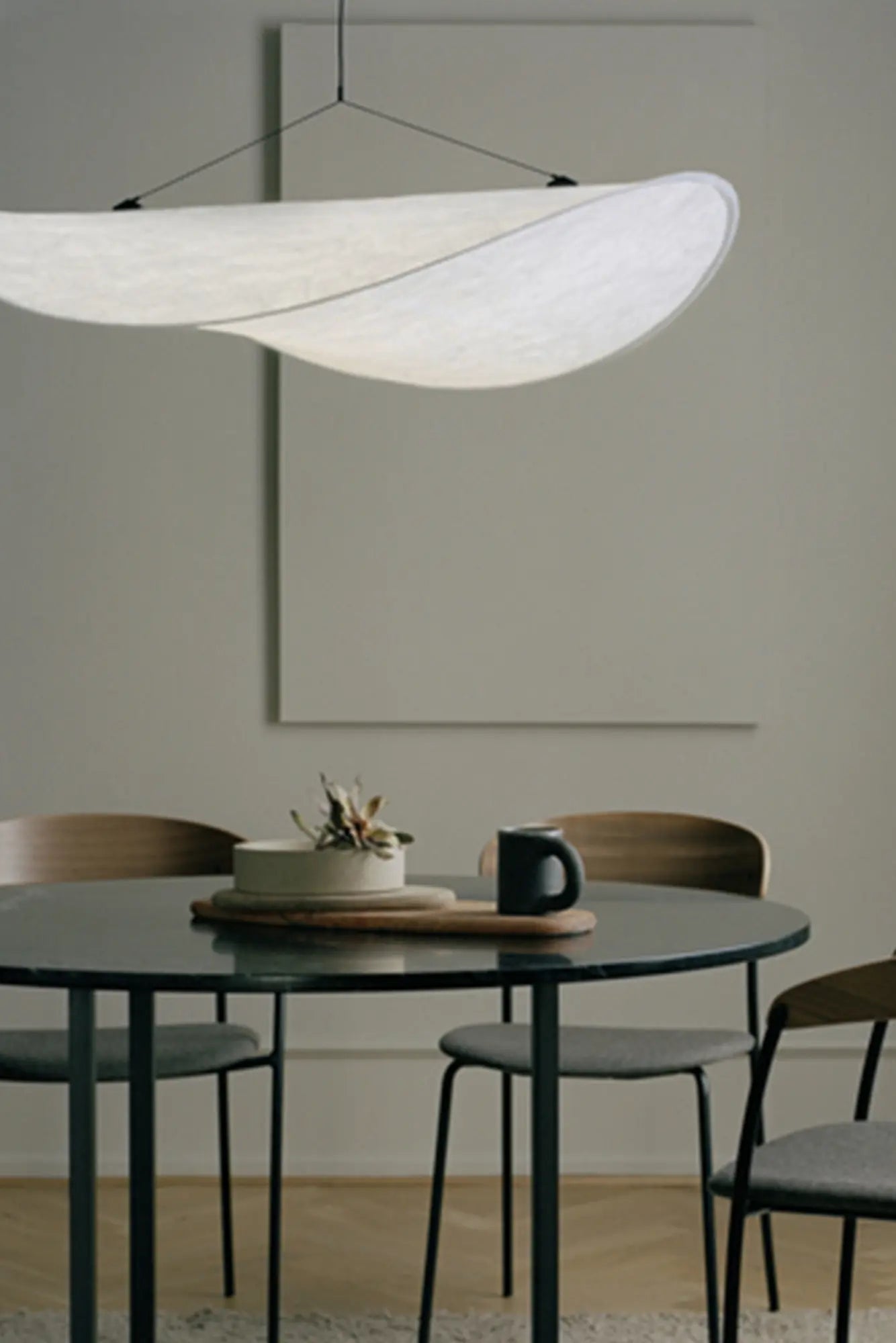 Modern black Tense Pendant Lamp hanging from ceiling in stylish interior