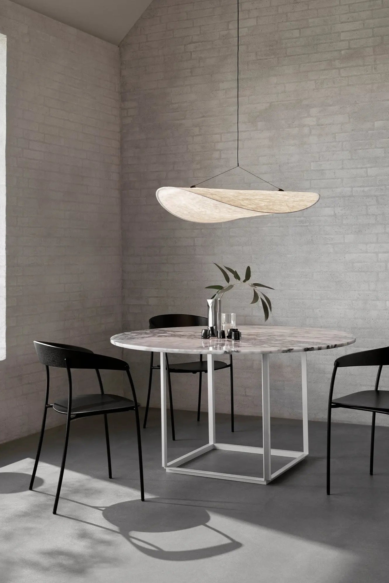Tense Pendant Lamp casting soft, diffused light in contemporary office space