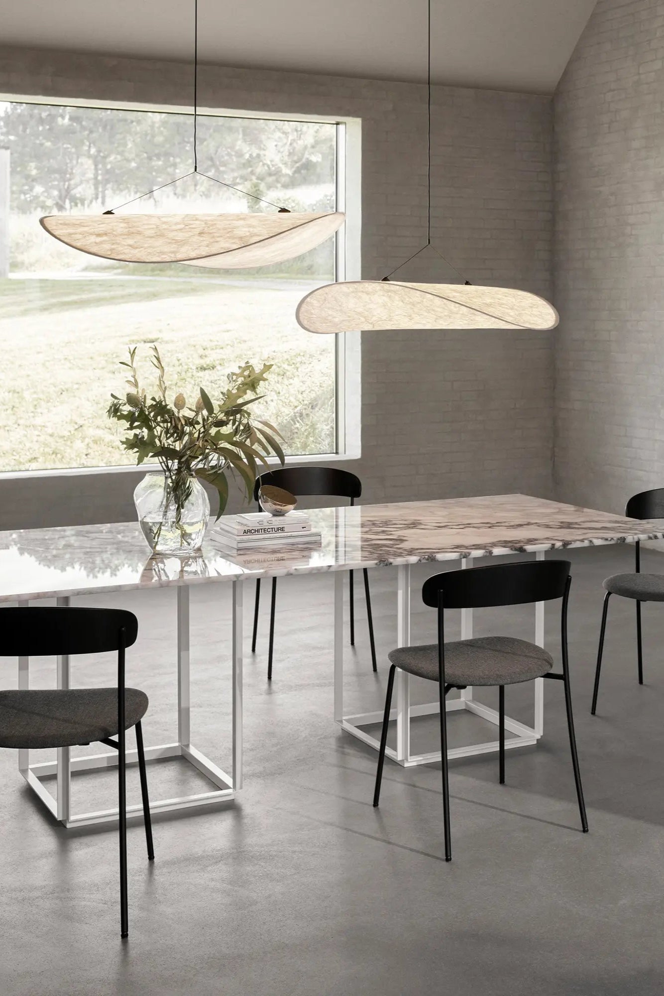 Modern black and gold Tense Pendant Lamp hanging from ceiling in stylish living room