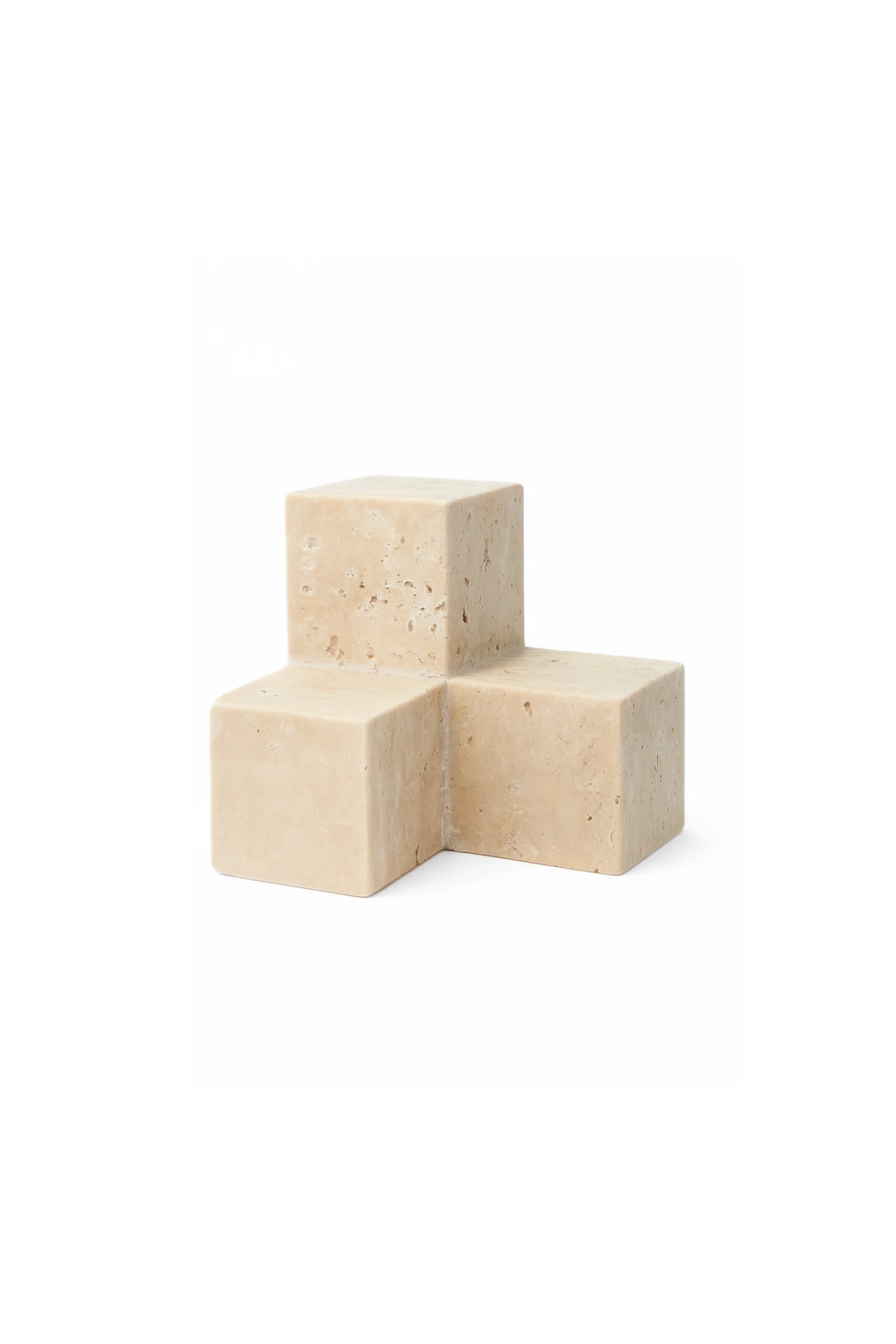 TAMO Tero Travertine Bookend. Light beige, porous natural travertine stone, cube-shaped, with a unique interlocking design. This authentic, architectural bookend is perfect for enhancing modern decor.