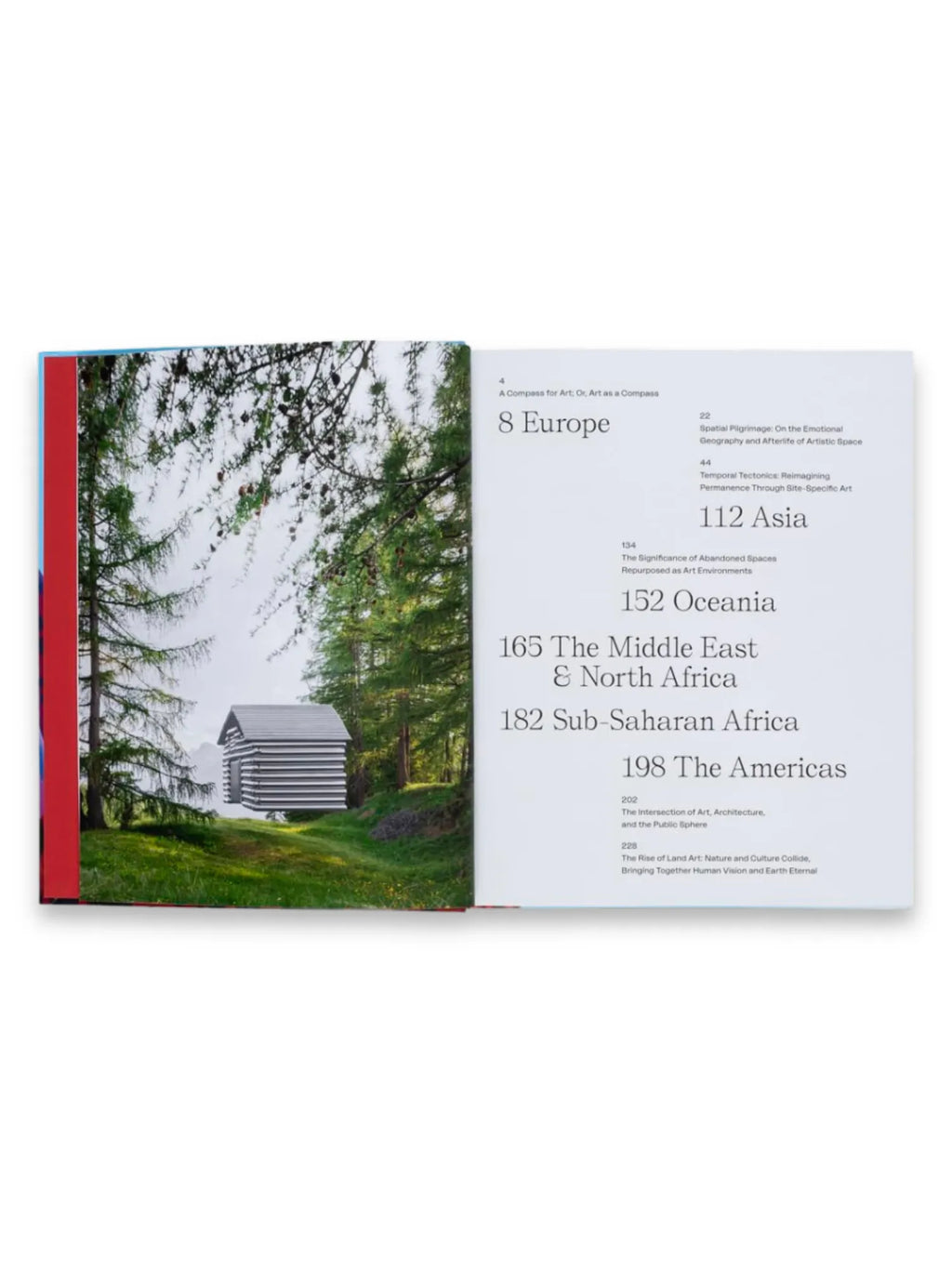 Book The Art Escapes Atlas, an open book displaying a vibrant red and blue spine, with one page featuring a striking photograph of a modern, striped, floating cabin amidst a lush green forest, while the opposite page presents a detailed table of contents with sections like "Europe," "Asia," and "The Americas." This captivating art and travel book is perfect for art enthusiasts and adventurous readers seeking inspiration for their next cultural journey.