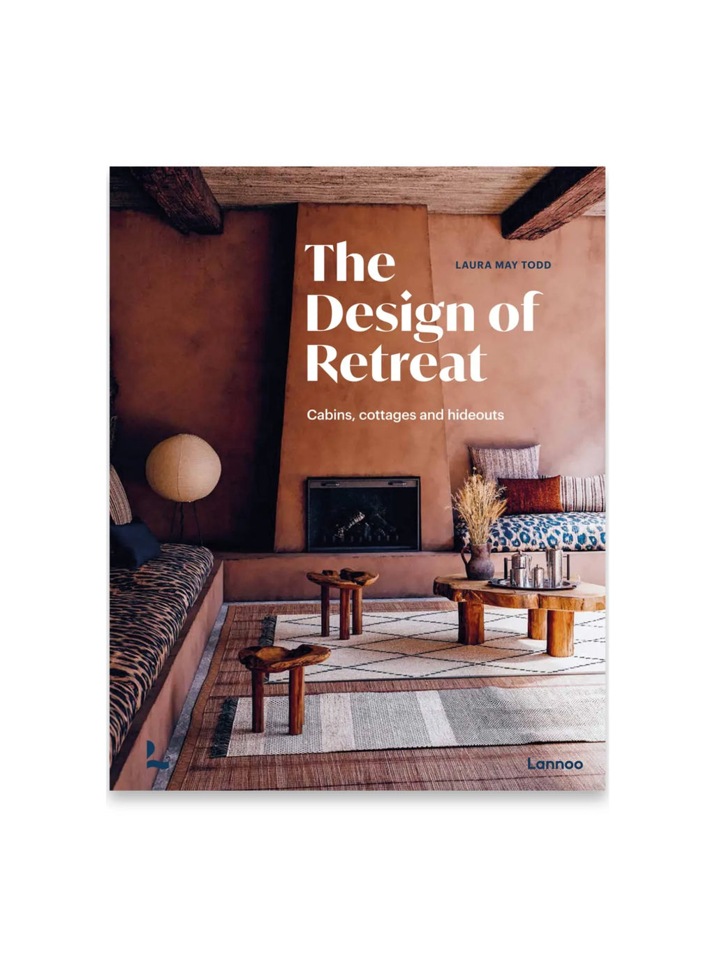Book The Design Retreat, a hardcover interior design book featuring a rustic, earthy living room with exposed wooden beams, a terracotta-colored fireplace, and a leopard print cushion bench. This inspiring book is perfect for design enthusiasts seeking unique cabin and cottage interior ideas.