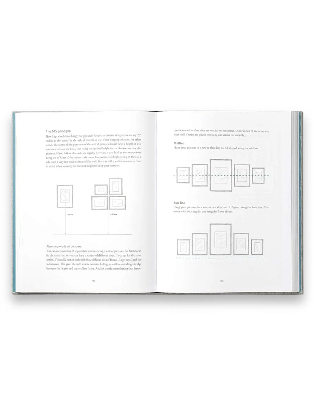 Book The Interior Design Handbook, showcasing an open page with crisp white paper and clear black text detailing "The 145 Principle" for picture hanging, featuring diagrams of various picture arrangements. This essential interior design book is perfect for aspiring designers and homeowners seeking practical, stylish guidance.