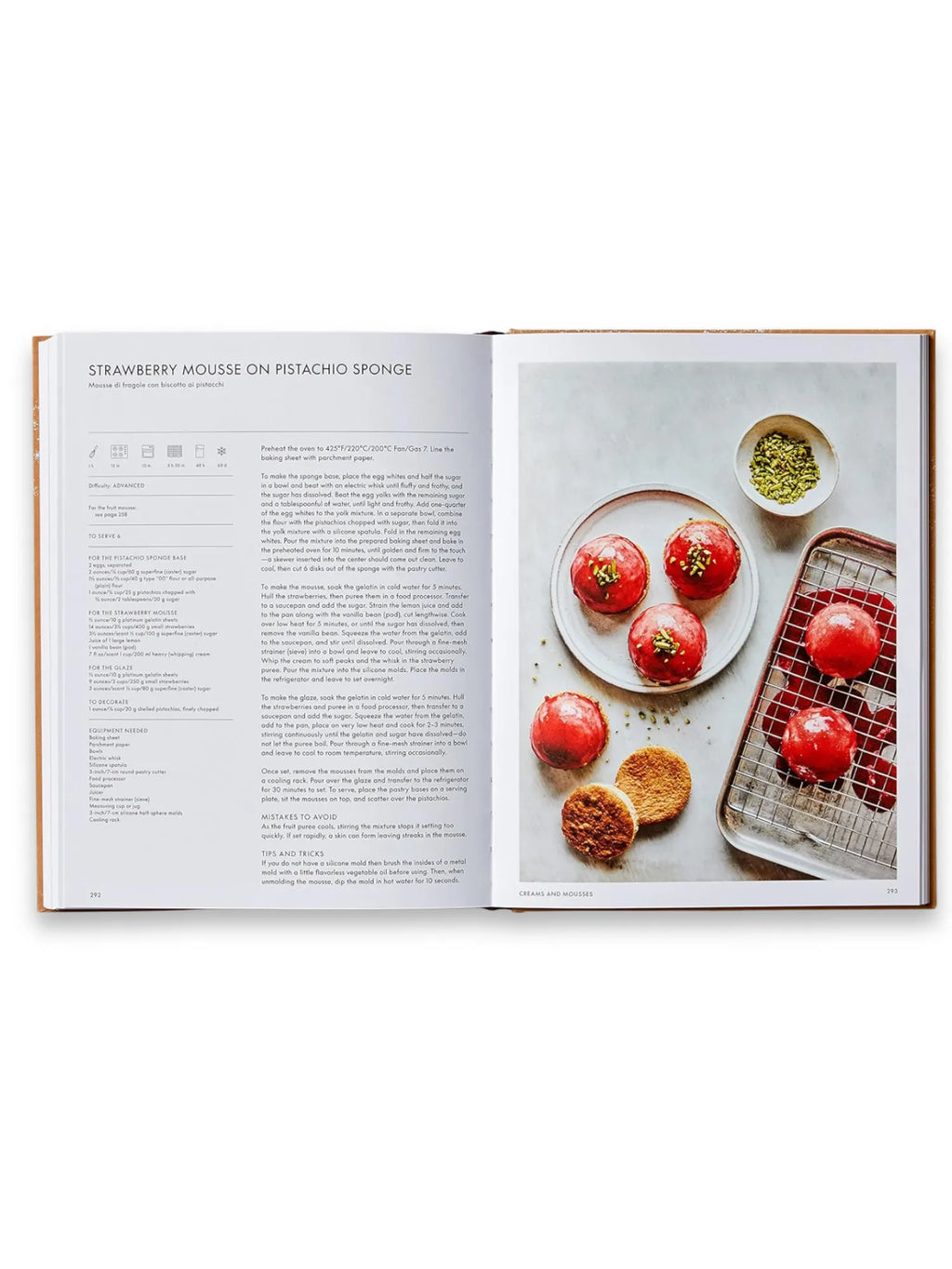 Book The Italian Bakery, an open cookbook displaying a vibrant recipe for "Strawberry Mousse on Pistachio Sponge" with glossy red-glazed desserts and golden sponge bases, alongside a bowl of chopped pistachios. This premium baking book is perfect for home bakers seeking authentic Italian dessert recipes.