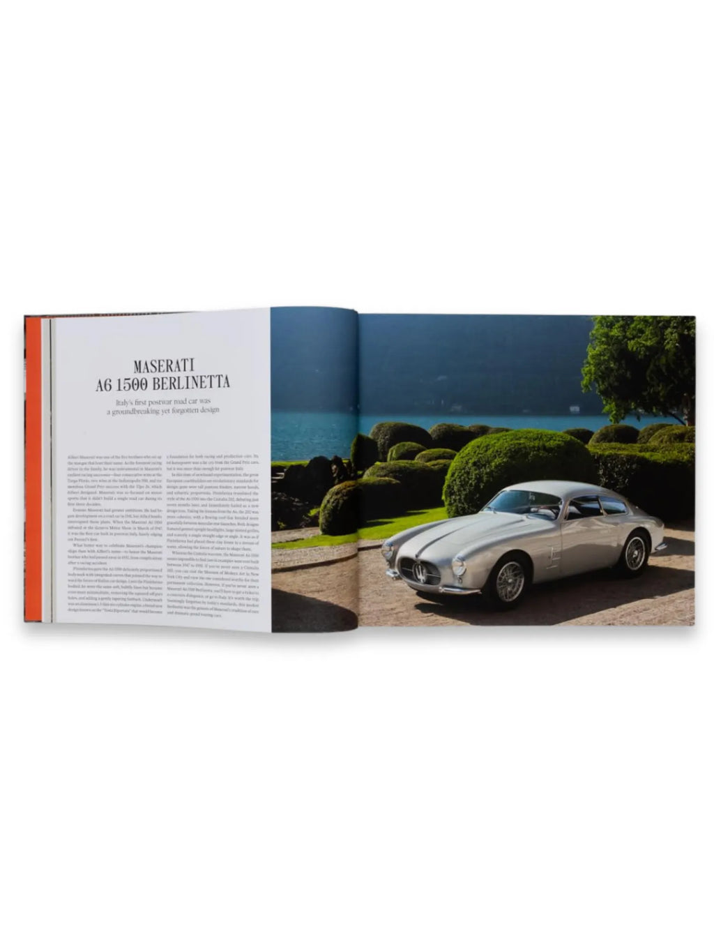 Book The Italians - Beautiful Machines, open to a spread featuring a silver Maserati A6 1500 Berlinetta sports car parked on a stone drive with a lake and sculpted green hedges in the background. This premium automotive history book is perfect for classic car enthusiasts and design aficionados.