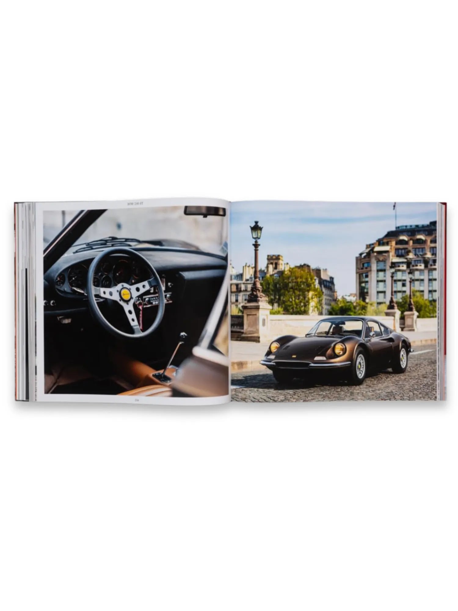 Book The Italians - Beautiful Machines, open to a two-page spread featuring luxury Italian cars. The left page displays a detailed interior shot of a vintage sports car with a classic steering wheel and brown leather, while the right page shows a sleek dark bronze sports car parked on a cobblestone street with classic European architecture in the background. This premium automotive photography book is perfect for car enthusiasts and collectors of Italian car history.