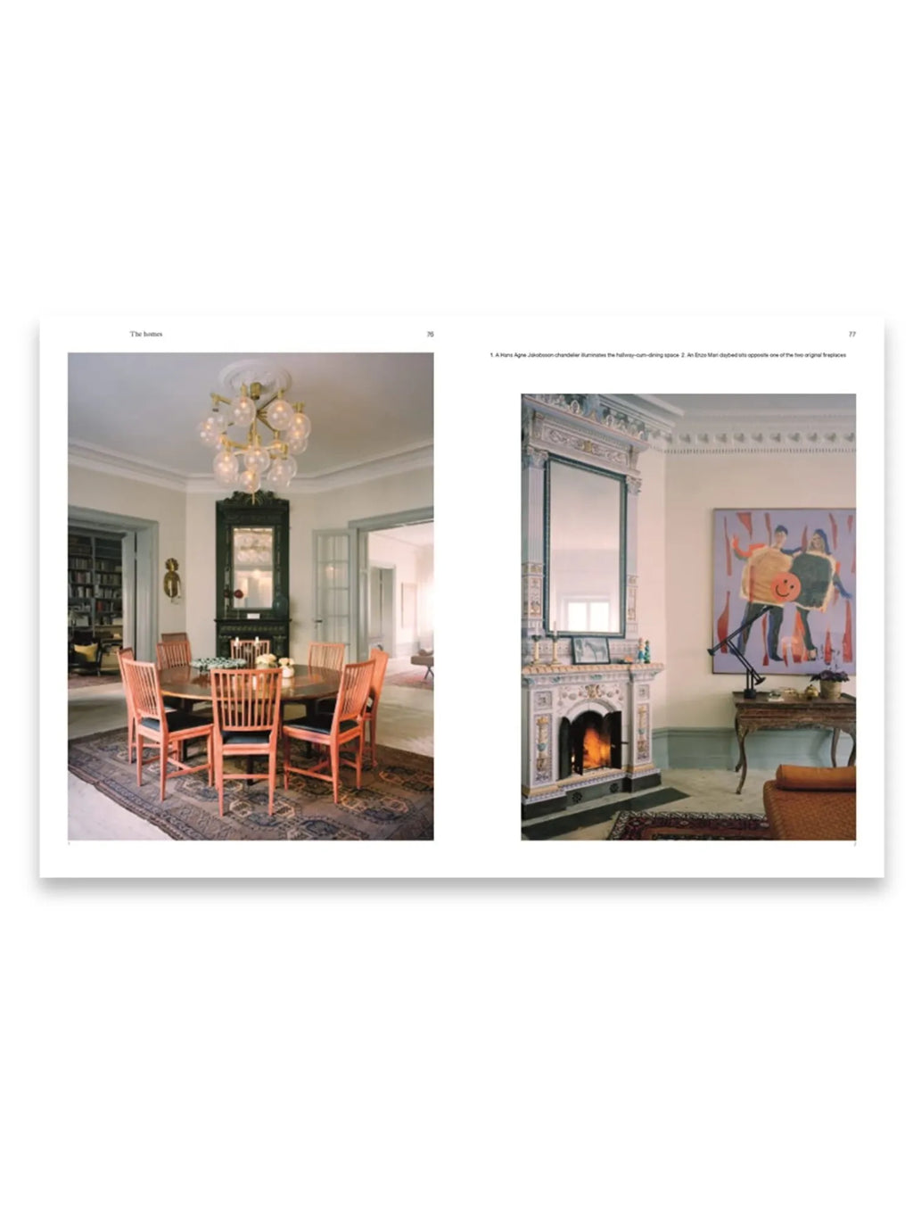 Book The Monocle Book of Homes, featuring two open pages showcasing elegant interior design photography. The left page displays a dining room with a round wooden table, coral-colored chairs, a patterned rug, and a brass bubble chandelier. The right page shows a luxurious fireplace with intricate tile work, a large mirror, and a contemporary abstract painting. This premium interior design book is perfect for decor enthusiasts and homeowners seeking stylish home inspiration.