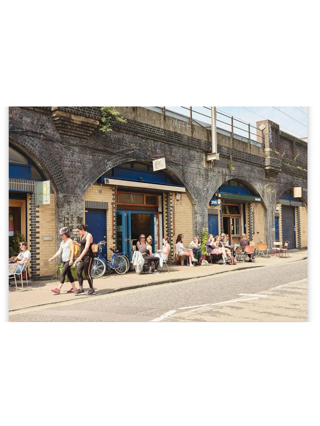 Book The Monocle Guide to Building Better Cities, featuring a vibrant street scene with brick archways, cafes, and people enjoying outdoor seating. This urban planning guide is perfect for professionals, students, and enthusiasts interested in creating more livable and sustainable cities.