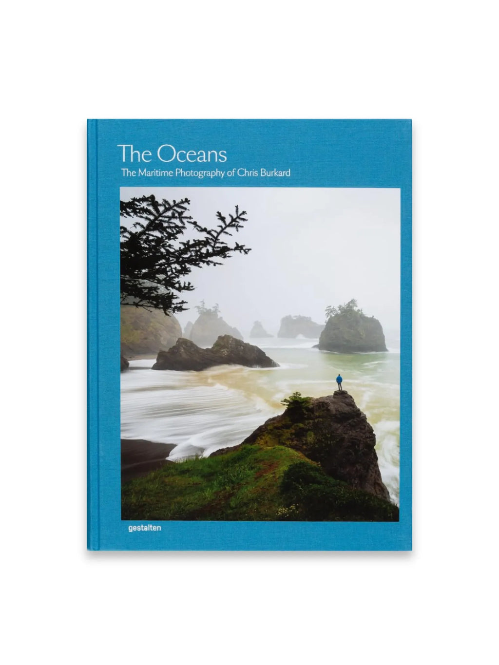 Book The Oceans, a hardcover photography book featuring a vibrant teal blue linen-textured cover with white title text and a stunning maritime photograph by Chris Burkard on the front. This collectible art book is perfect for photography enthusiasts and those who appreciate breathtaking ocean landscapes.