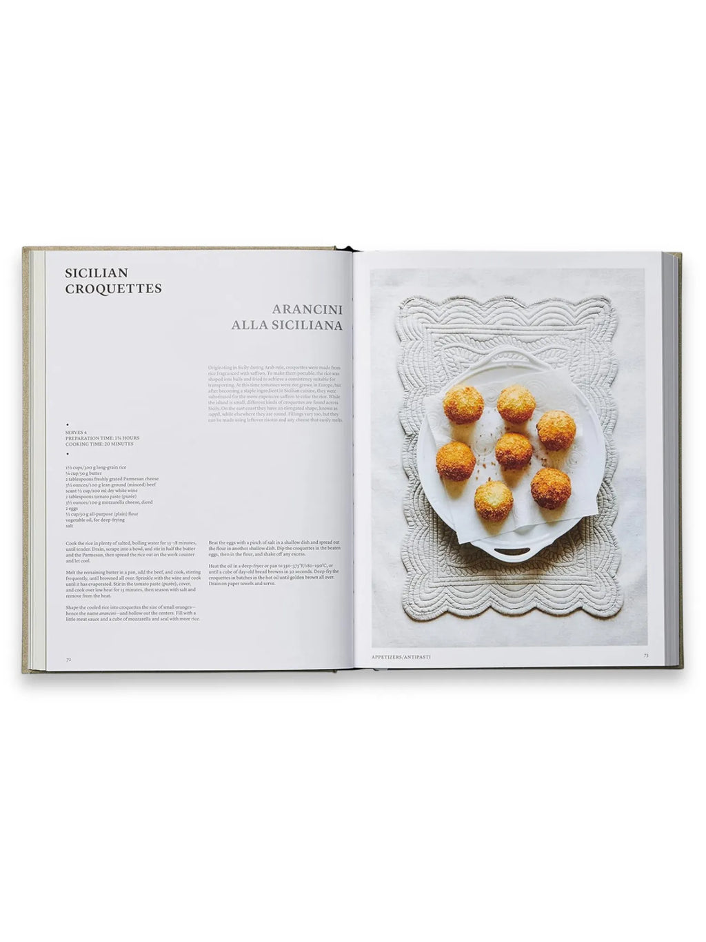 Book The Silver Spoon, open to a recipe page featuring "Sicilian Croquettes" and "Arancini alla Siciliana" with an appetizing photo of golden-brown arancini on a white plate with paper towels, resting on a decorative white embroidered placemat. This premium cookbook is perfect for home chefs and culinary enthusiasts seeking authentic Italian recipes.