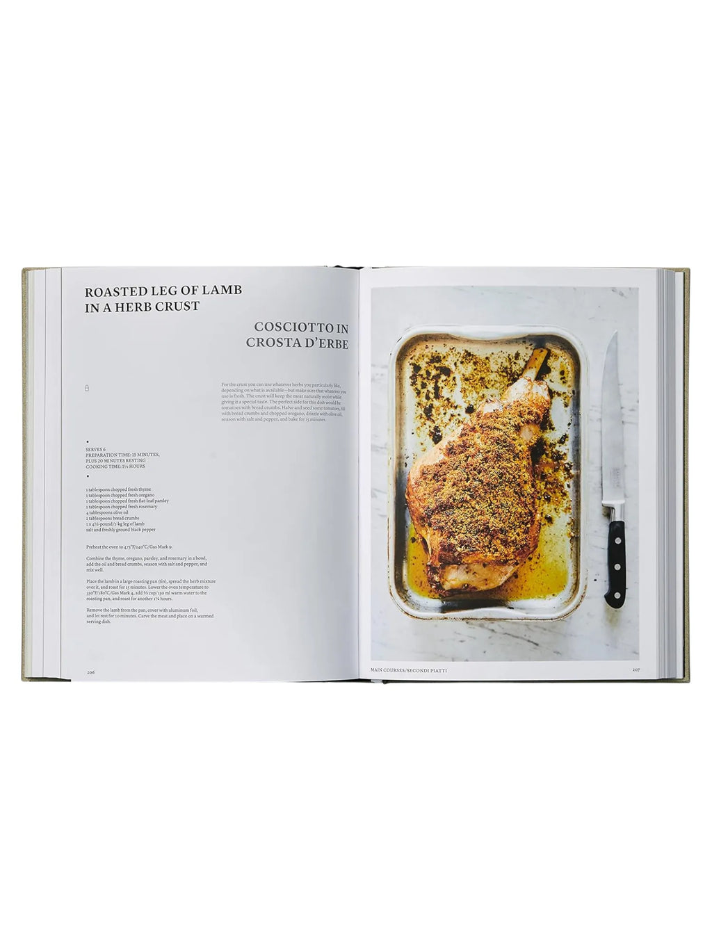 Book The Silver Spoon, open to a recipe for "Roasted Leg of Lamb in a Herb Crust" with a full-page glossy photo of a golden-brown, crispy herb-crusted lamb leg in a metal roasting pan, accompanied by a chef's knife, on a white marble surface. This premium cookbook is perfect for home cooks and culinary enthusiasts seeking authentic, delicious Italian recipes.