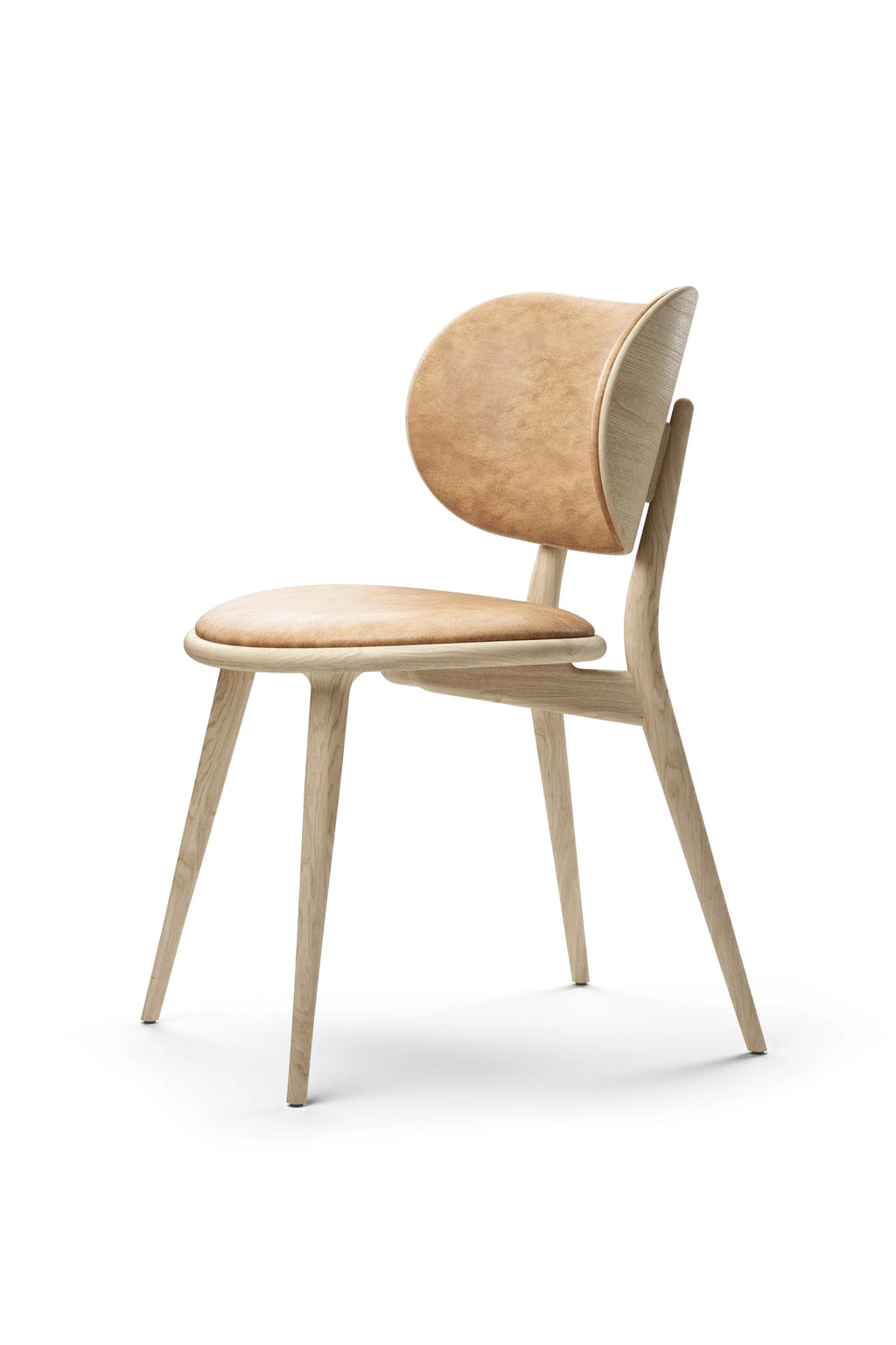 Mater The Dining Chair, a contemporary light oak dining chair with a curved backrest and a tan leather padded seat, showcasing its natural wood grain and elegant design, presented at an angle on a clean white background.