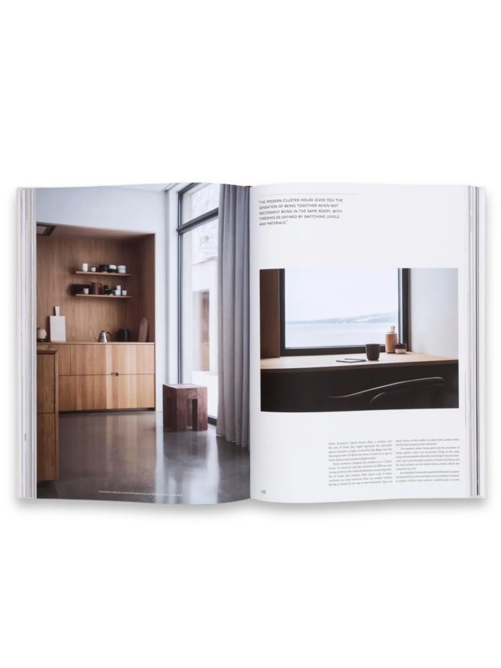Book The Touch, an open architectural design book displaying minimalist interior design with warm wooden cabinetry, concrete floors, and expansive windows. This book is perfect for interior designers and architecture enthusiasts seeking modern home inspiration.