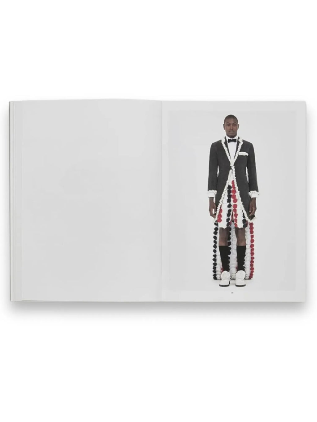 Book Thom Browne, an open fashion book revealing a striking editorial image of a model in a unique gray tuxedo jacket with a cascading red, white, and black pom-pom train. This visually engaging book is perfect for fashion enthusiasts and students interested in avant-garde design and style.