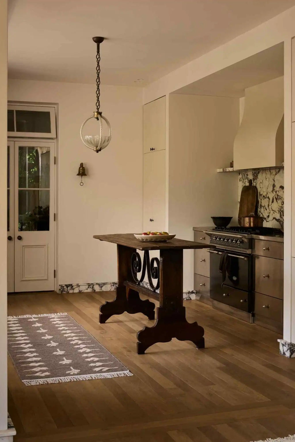 Cappelen Dimyr Colonnade No.09 Rug, a rectangular hand-knotted wool runner rug featuring a soft grey base with an organic pattern of off-white abstract shapes and short fringe ends. This textured wool rug is perfect for adding a rustic minimalist or organic modern touch to kitchen floors, hallways, or entryways.