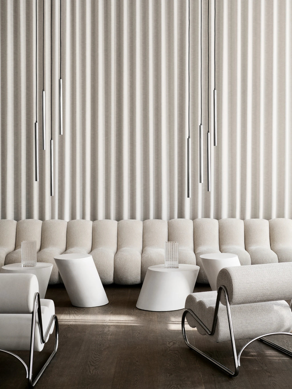 NORR11 Tilt Side Table, a modern minimalist side table featuring a clean matte white finish and a striking sculptural form. Its cylindrical shape is dramatically angled at the base, creating a dynamic tilted silhouette that adds contemporary flair. Perfect as an accent table for organic modern living rooms, minimalist bedrooms, or stylish lounge areas.