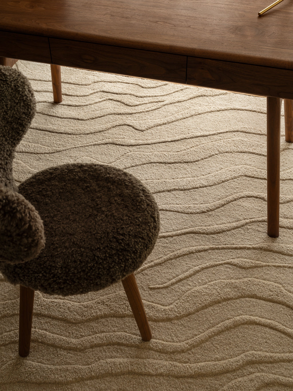 Tinted Objects Duvell Wool Rug, a plush, light beige hand-tufted wool area rug featuring a sophisticated wavy, organic pattern with varying pile heights. This luxurious floor covering is perfect for adding warmth and modern texture to living rooms or bedrooms for design-conscious homeowners.