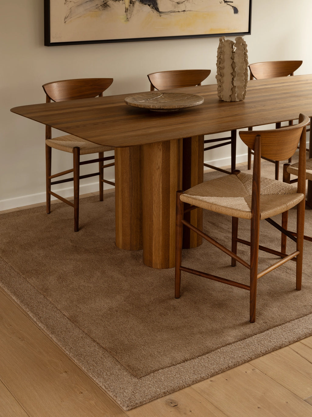 Tinted Objects Louis Wool Rug, a rectangular natural wool area rug in warm brown and tan earthy tones, featuring a plush, soft texture and a subtle tonal border. This organic modern rug is perfect for adding warmth and minimalist style to Scandinavian dining rooms or cozy living spaces.