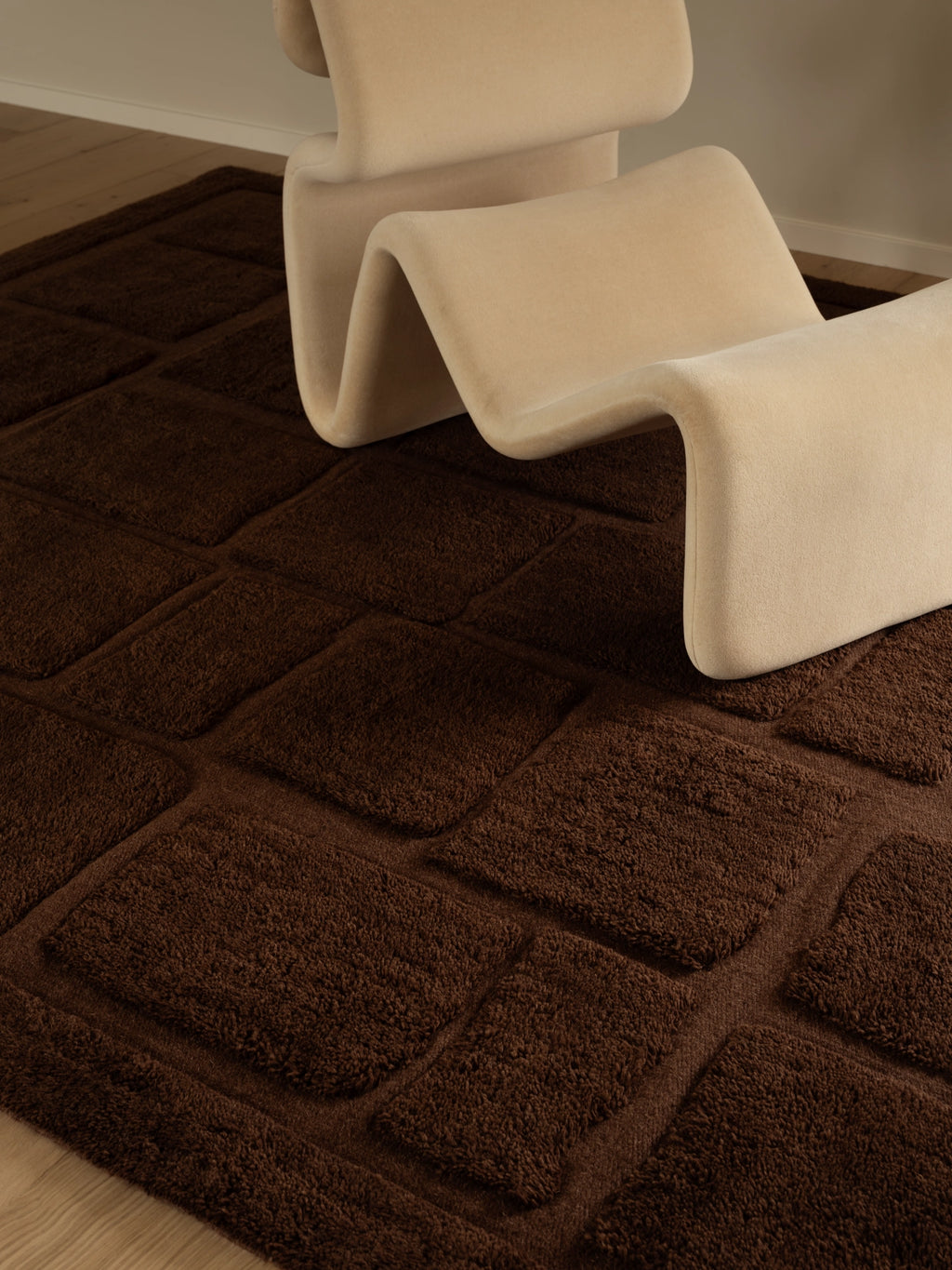 Tinted Objects Wandel Wool Rug, rich chocolate brown with a plush, textured grid pattern and soft wool pile. This stylish area rug adds warmth and modern elegance to any living room or bedroom.