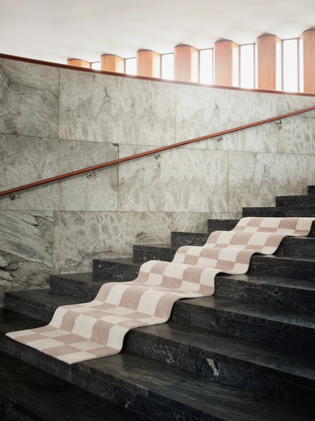Tinted Objects Hafstrom Wool Runner Rug, featuring a charming checkered pattern in soft cream and blush pink, made from luxurious wool. This stylish, durable runner rug is perfect for adding warmth and modern elegance to hallways or staircases in contemporary homes.