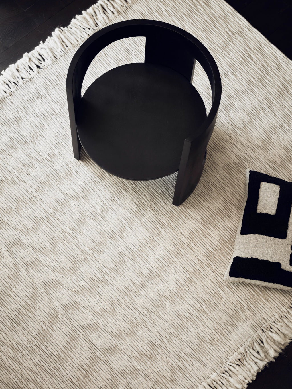 Tinted Objects Fagerlund Wool Rug, a premium cream and taupe striped hand-loomed area rug with textured fringes. This elegant, durable floor covering is perfect for adding warmth and sophisticated style to modern living rooms or bedrooms.