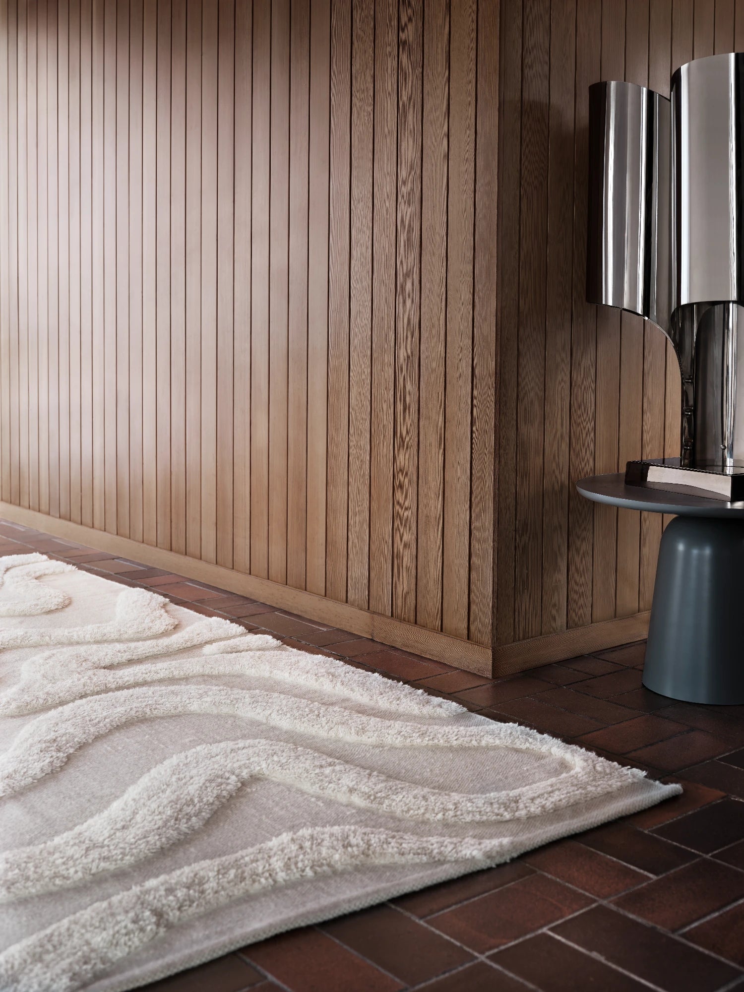 Tinted Objects Norlander Wool Rug, a luxurious cream-colored modern area rug with an abstract raised wave pattern and plush texture. This elegant rug is perfect for adding warmth and sophisticated style to contemporary living spaces and bedrooms.