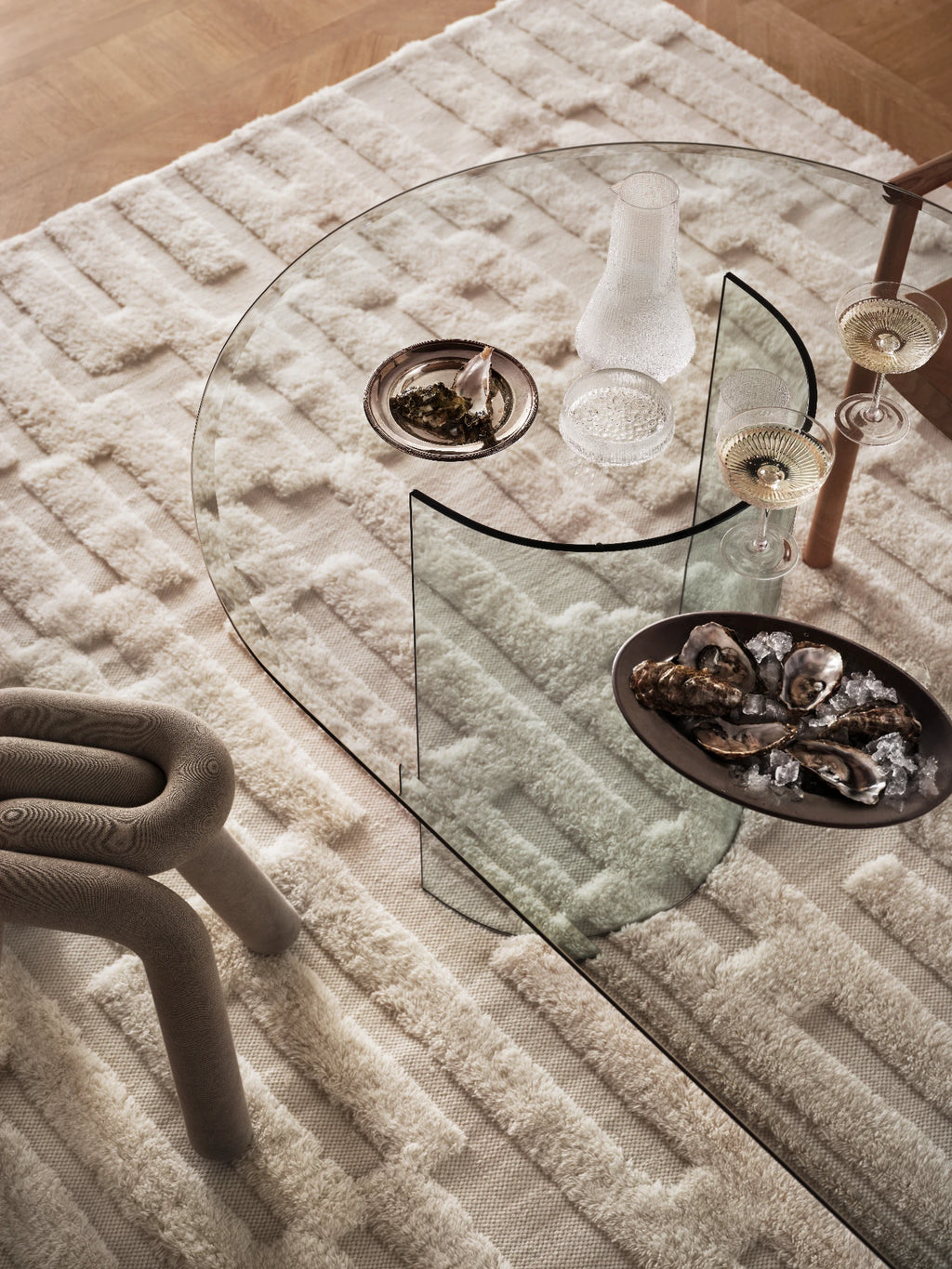 Tinted Objects Bielke Wool Rug, a luxurious cream-colored area rug with a stylish raised geometric pattern of plush, textured wool. This premium, soft floor covering adds warmth and modern elegance to any living space.