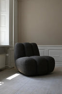 Modern and comfortable brown leather toe lounge chair with cushioned seat and armrests