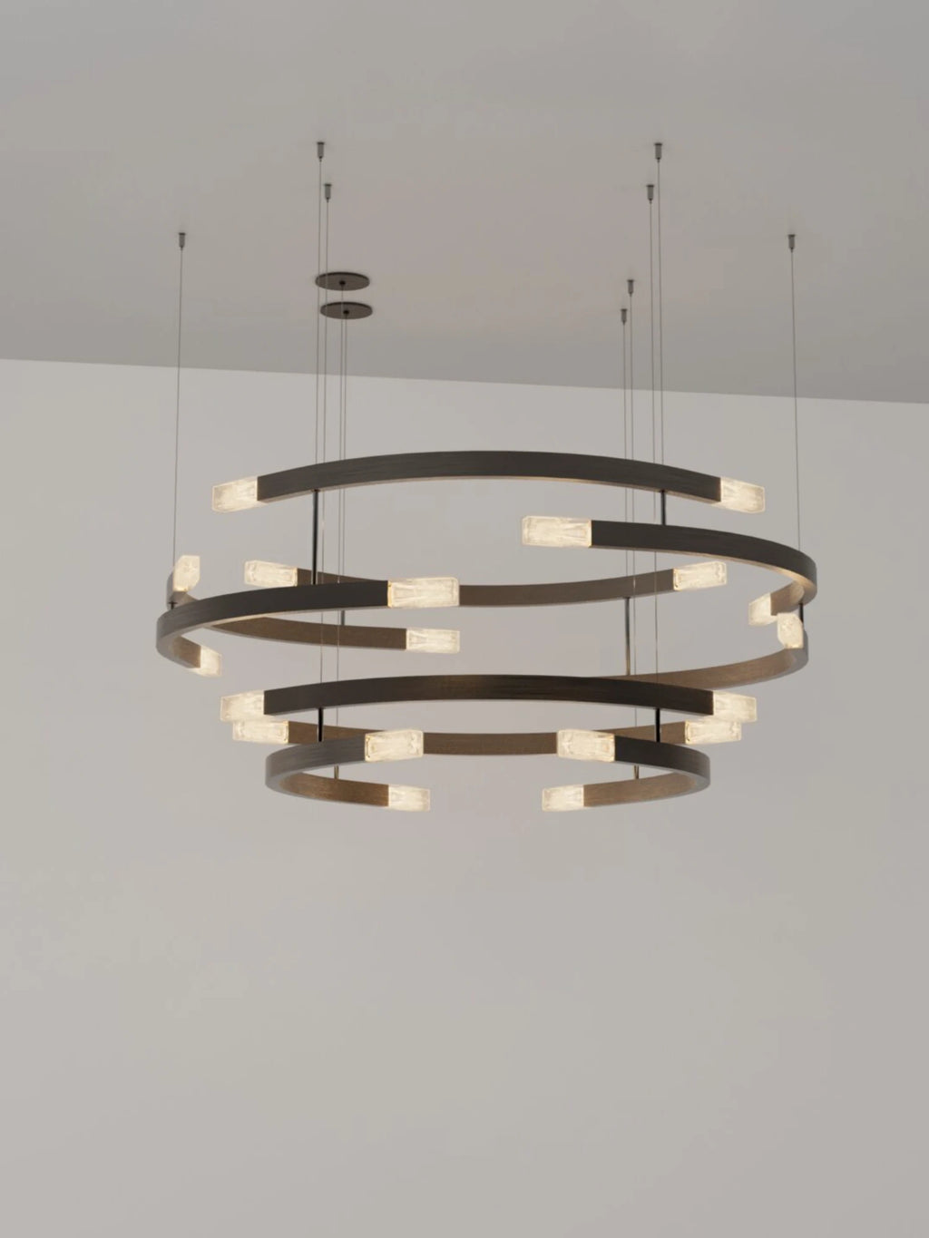 CTO Lighting Trace Circular Halo Chandelier, a luxurious modern multi-ring chandelier featuring multiple dark bronze finished metal halos arranged in an elegant, sculptural spiral form.
