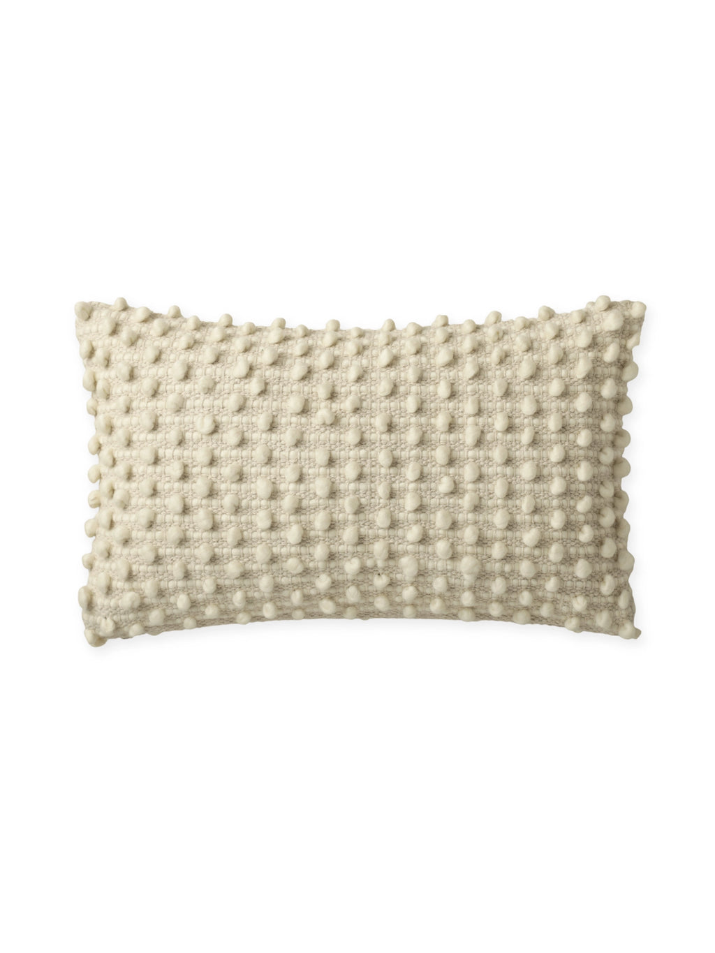Tinted Objects Tuhlin Throw Pillow, a rectangular cream-colored decorative cushion with a textured bobble knit design and soft pom-pom accents. This stylish accent pillow is perfect for adding cozy comfort and texture to any sofa, bed, or armchair in a modern living space.