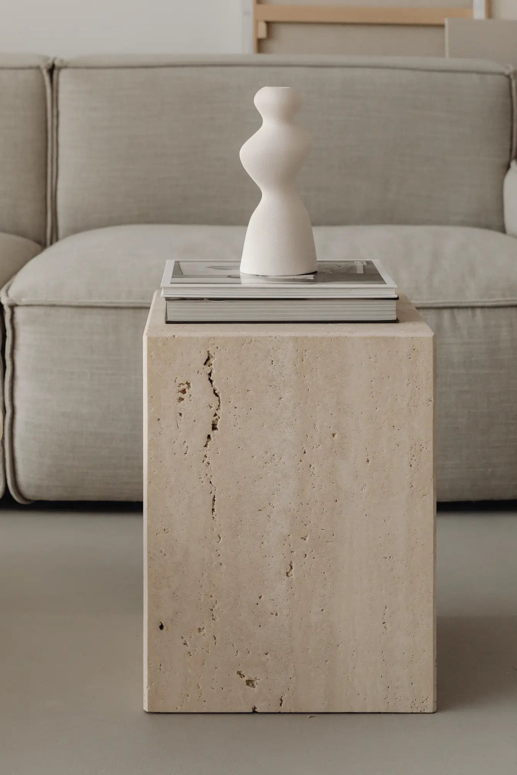 Coi Travertine Pillar standing tall in a modern interior design