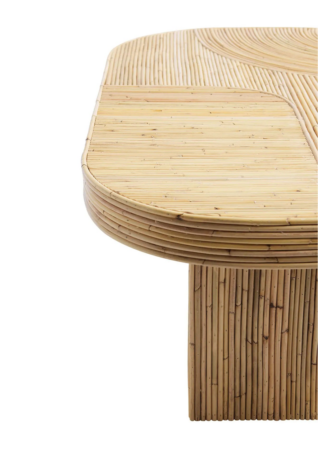 Tine K Viva Rattan Table, a natural light blonde rattan coffee table featuring a rounded rectangular top with a striking curved pattern created by individually laid rattan poles, and a sturdy cylindrical base constructed from vertical rattan. Perfect as an organic modern or coastal living room coffee table, ideal for bohemian-inspired interiors.
