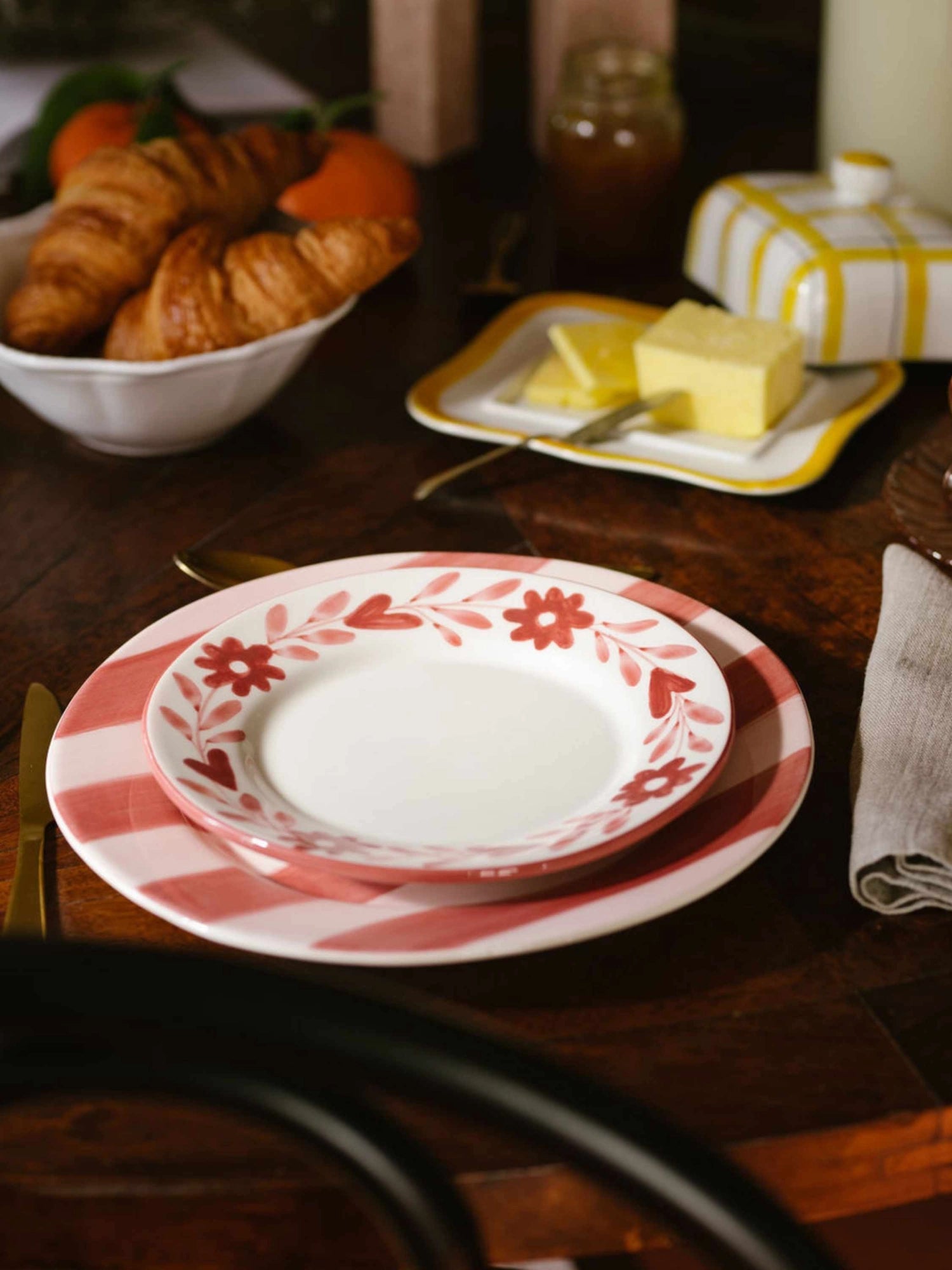 Valsa Home Red Flowers Hand-Painted Dessert Plate - Set of 4, a charming ceramic dessert plate featuring a hand-painted border of coral red flowers and leafy vines on a crisp white background with a subtle pink rim. This whimsical floral tableware set is crafted from smooth, glossy ceramic, perfect for adding a touch of cottagecore charm or rustic farmhouse style to breakfast, brunch, or dessert settings.