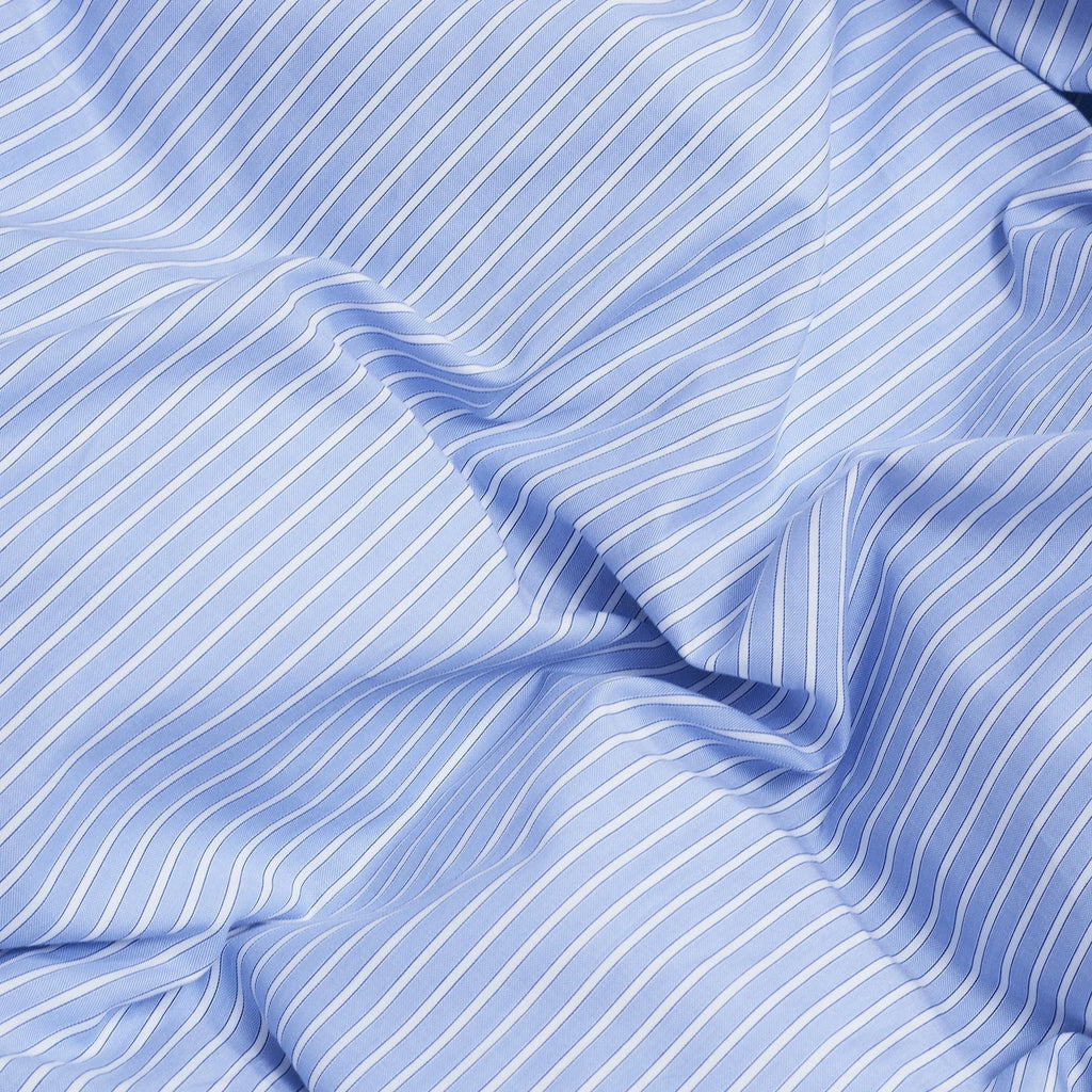 Magniberg Wall Street Duvet Cover - Stripe Light Blue Oxford, a premium light blue and white striped Oxford cotton fabric featuring a classic pinstripe design and soft, textured weave. This tailored bedding is perfect for creating a crisp, contemporary, or classic bedroom aesthetic.