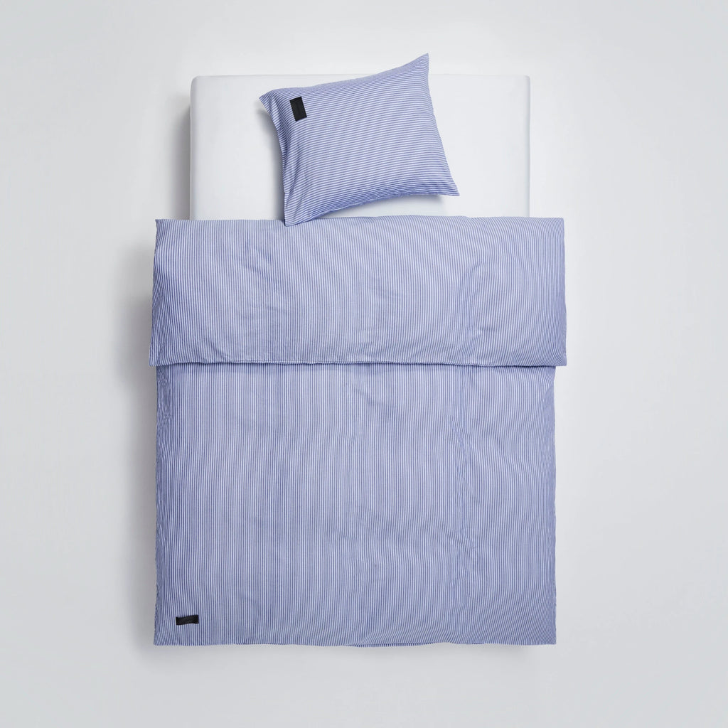 Magniberg Wall Street Pillow Case - Stripe Dark Blue, a classic and crisp pillowcase crafted from fine quality cotton fabric, featuring a timeless pattern of thin dark blue and white vertical stripes.
