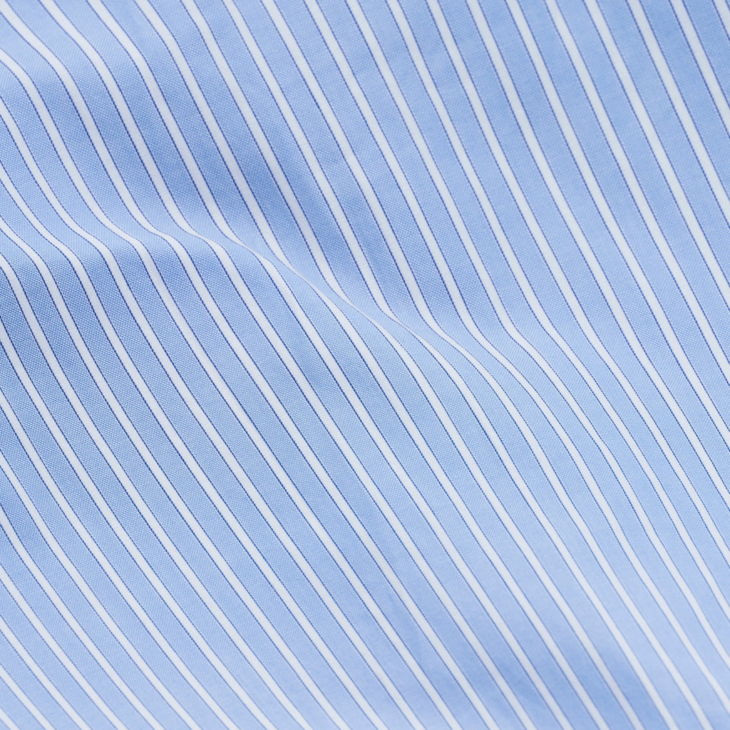 Magniberg Wall Street Pillow Case - Stripe Light Blue Oxford, a premium Oxford cotton pillowcase showcasing classic light blue and white stripes with fine dark blue woven detailing, creating a rich texture.