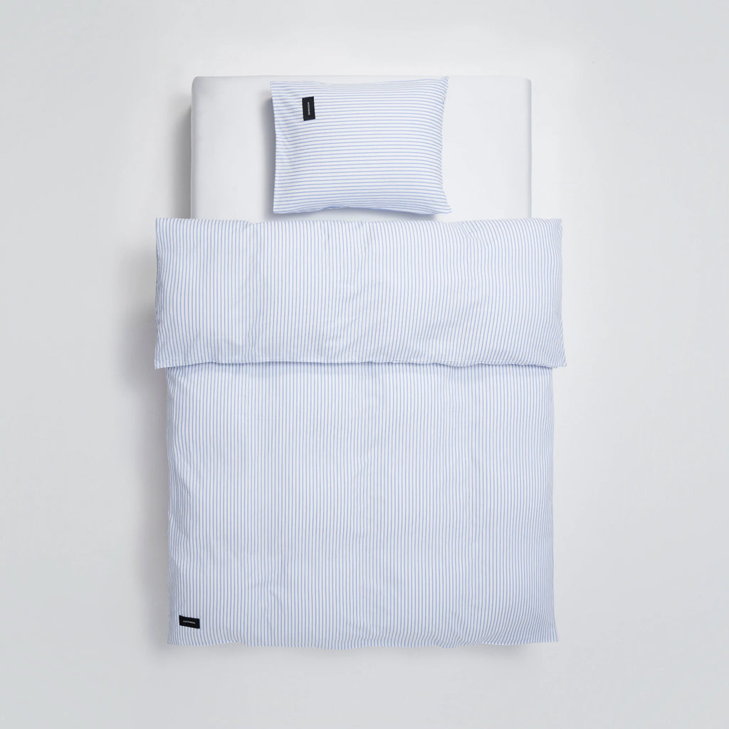 Magniberg Wall Street Pillow Case - Stripe White, a classic square pillowcase crafted from crisp cotton fabric, featuring a timeless blue and white pinstripe pattern.