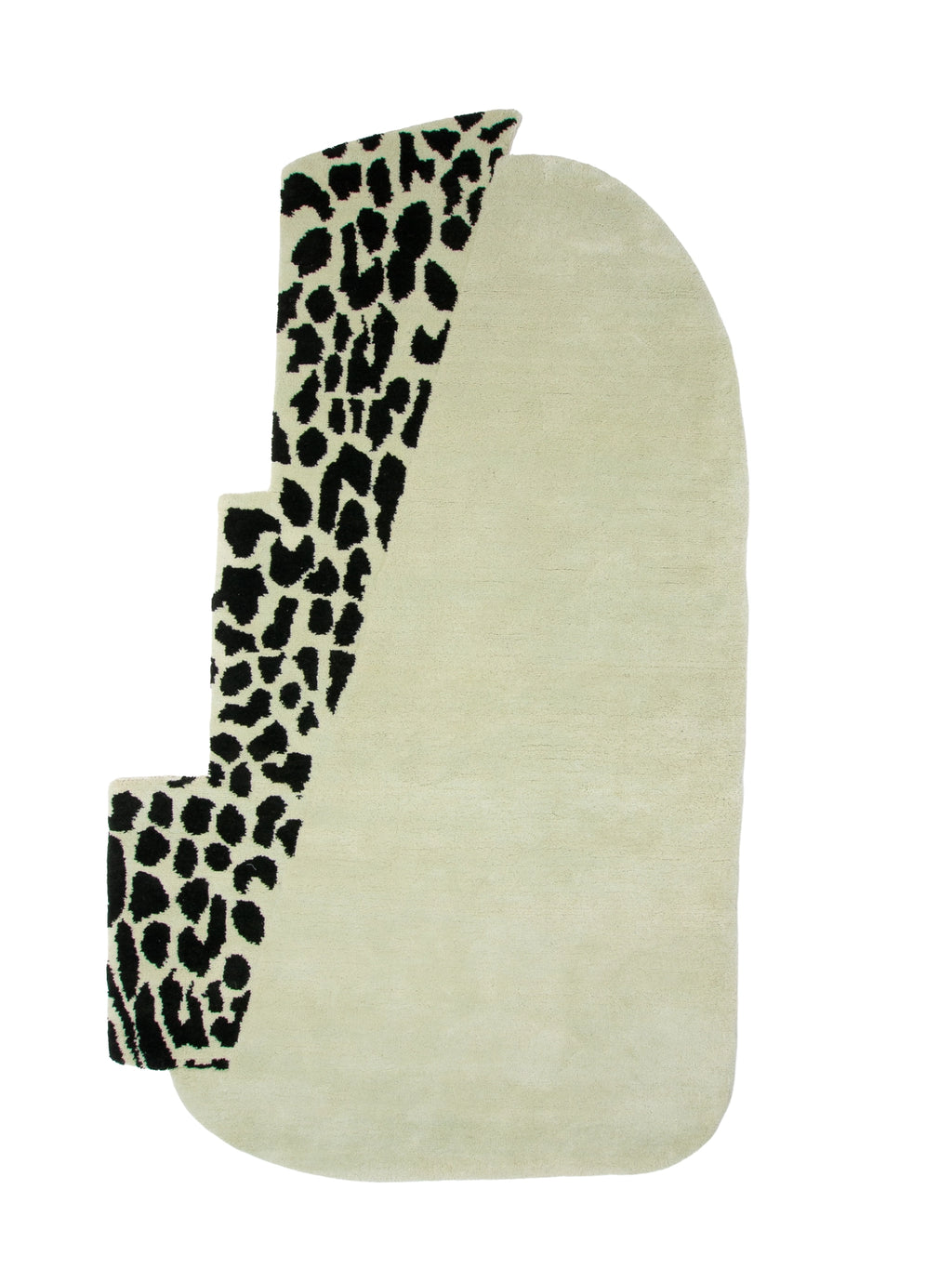 Haus Üger Wild Mist Rug, an abstract hand-tufted wool rug featuring an organic, irregular shape with a plush soft pile. It showcases a striking design with a rounded cream-colored base accented by a bold, stepped section in a black animal spot pattern. This contemporary and playful area rug is perfect for adding a maximalist statement to modern living rooms, bedrooms, or creative spaces.