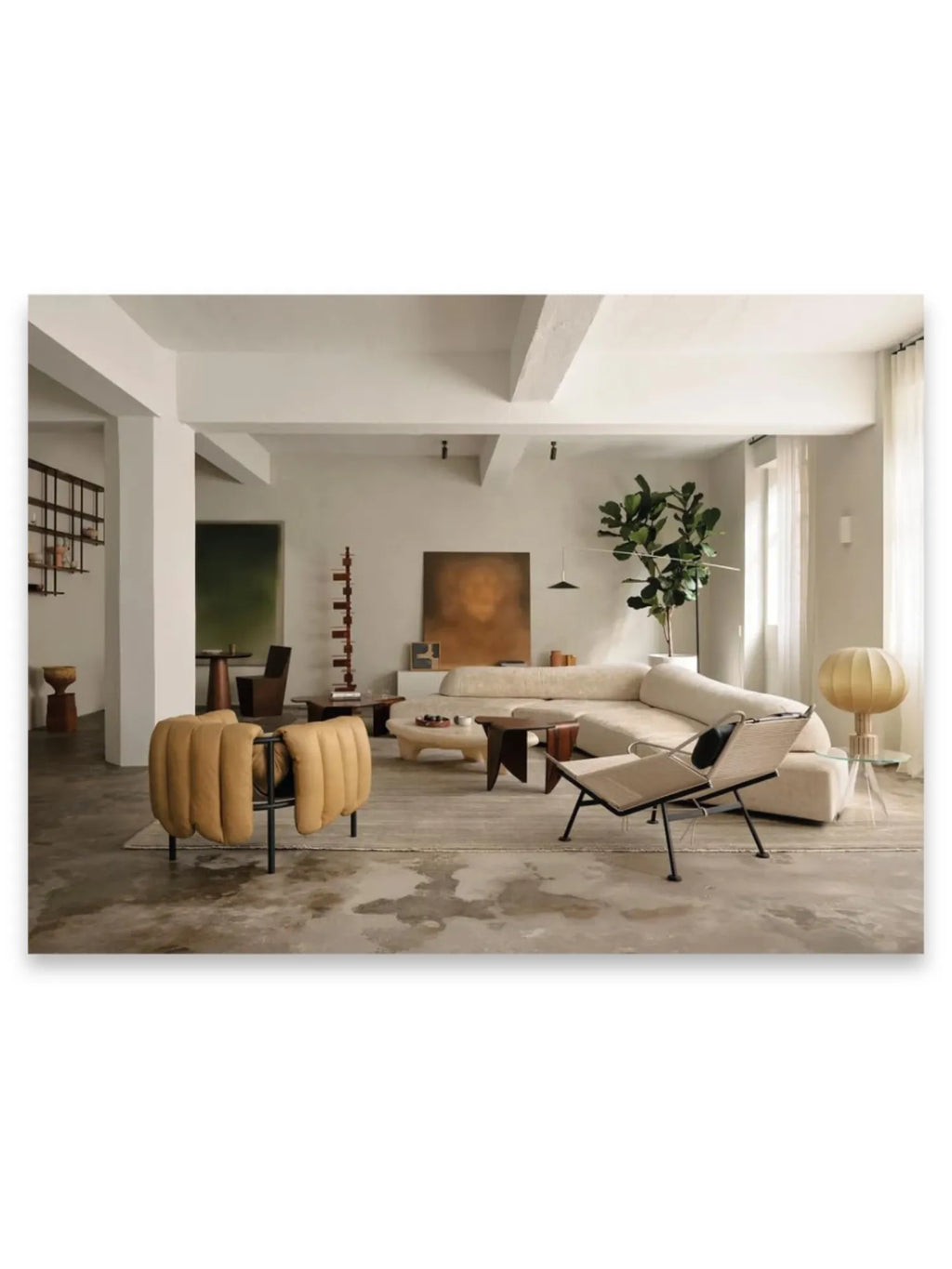 Book World’s Finest Apartments, featuring a stylish, spacious living room with an off-white sectional sofa, a unique tan upholstered armchair, and modern minimalist decor. This interior design book is perfect for design enthusiasts seeking inspiration for luxury apartment living.