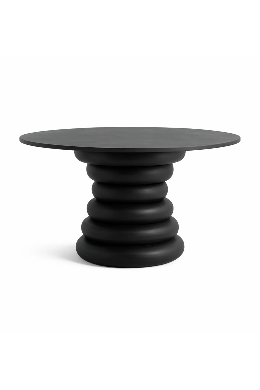 Nordal Yalu Dining Table, a striking matte black round dining table featuring a bold, sculptural stacked-ring base and a smooth, minimalist tabletop. Crafted from black-stained wood or a durable composite with an organic modern aesthetic, its unique silhouette makes it a true statement piece. Perfect for a contemporary dining room, modern minimalist kitchen, or as a focal point in a brutalist-inspired interior.