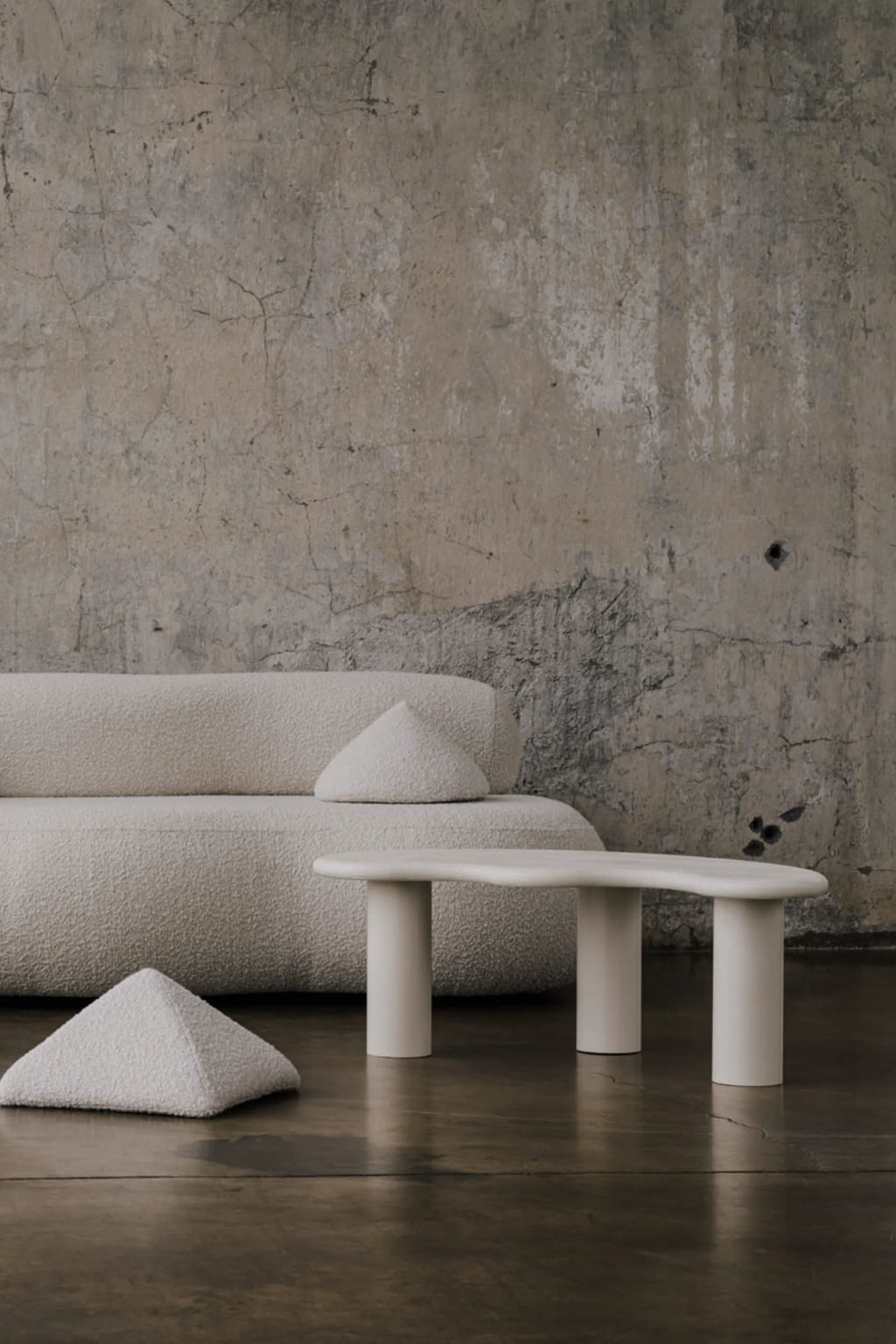NG DESIGN Object 078 Coffee Table, a minimalist ivory/off-white table with an organic, wavy top and two cylindrical legs, styled in a luxurious modern living space. Ideal for contemporary interiors.