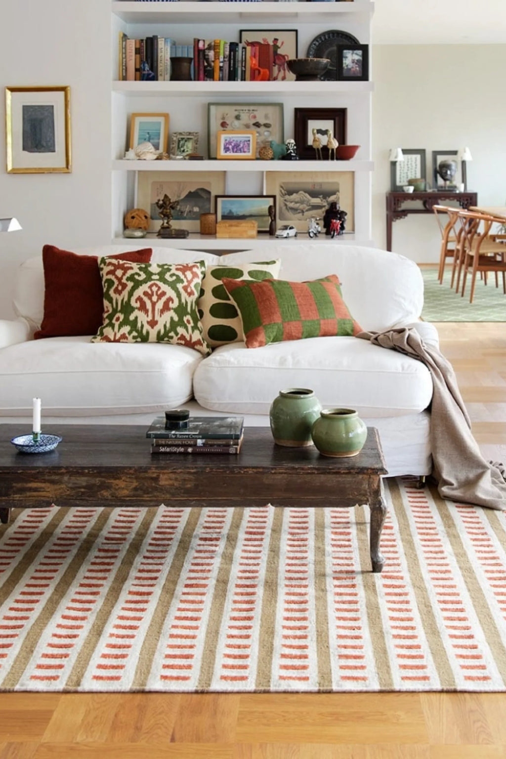 Chhatwal & Jonsson Samar Linen Throw Pillow, a handcrafted linen throw pillow featuring a vibrant green and rust ikat pattern against a cream background.