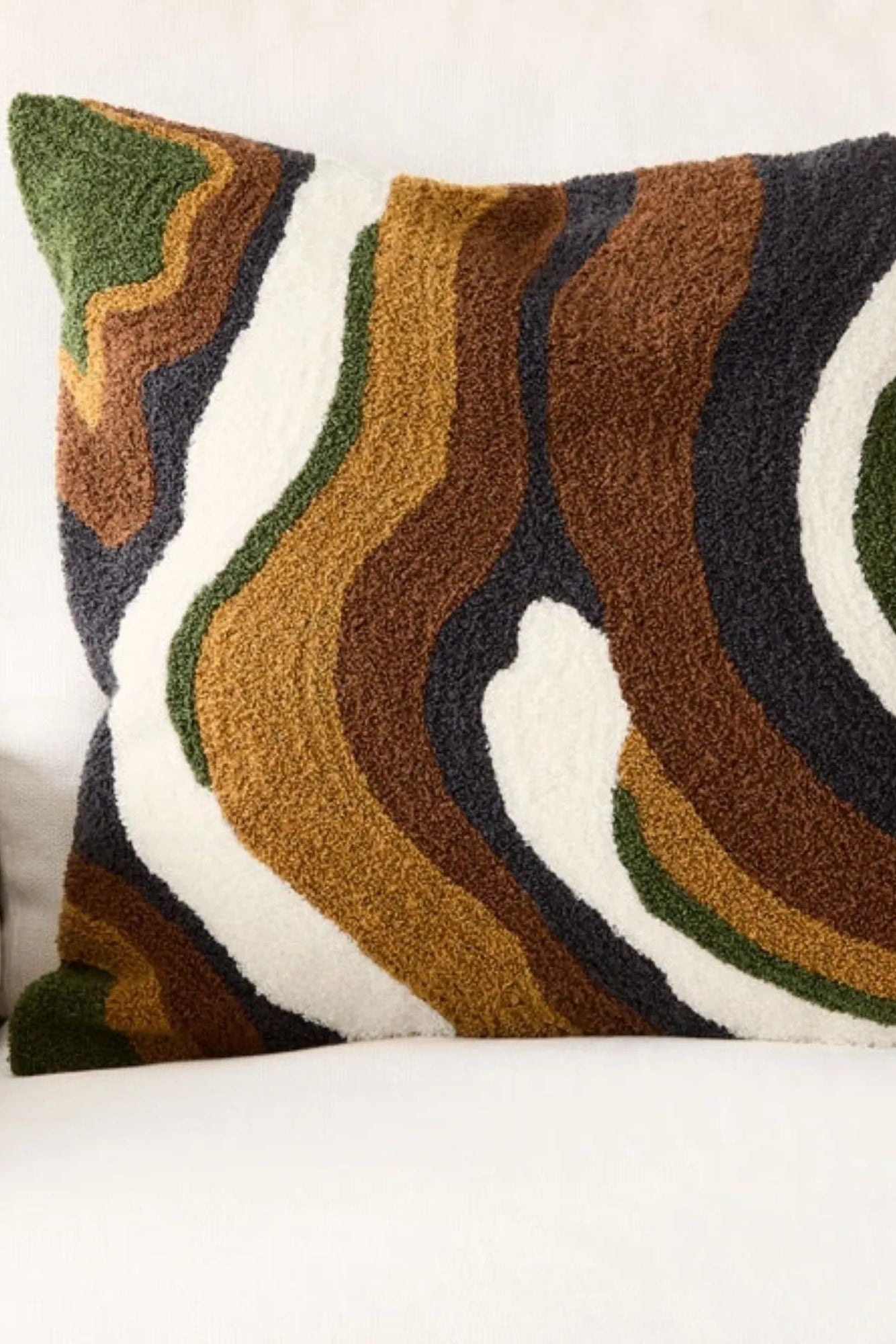 Cognac and masala colored pillow with cozy boucle texture and soft feel
