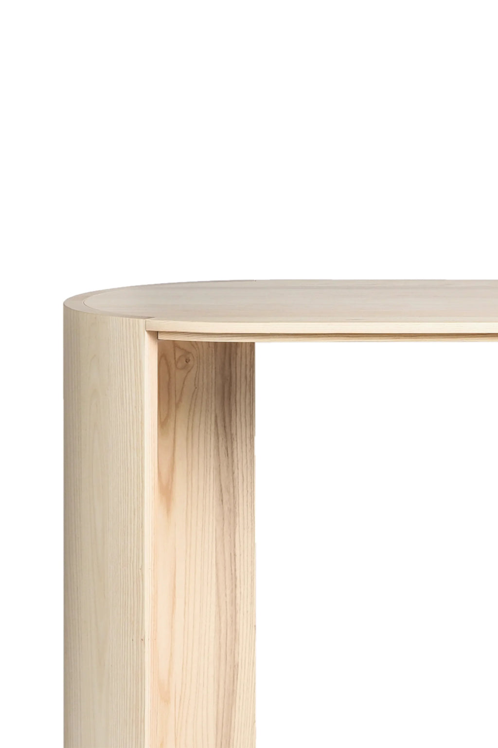 Made by Choice Airisto Desk, a close-up detail of the natural light wood desk's curved side panel, showcasing the beautiful light grain and smooth, modern design, against a bright white background.