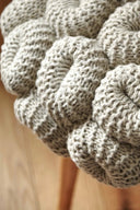 Handcrafted knitted stool made from natural, eco-friendly materials for cozy home decor