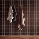 Puro Towel Set hanging on a stylish towel rack, adding a touch of sophistication and functionality to the bathroom decor