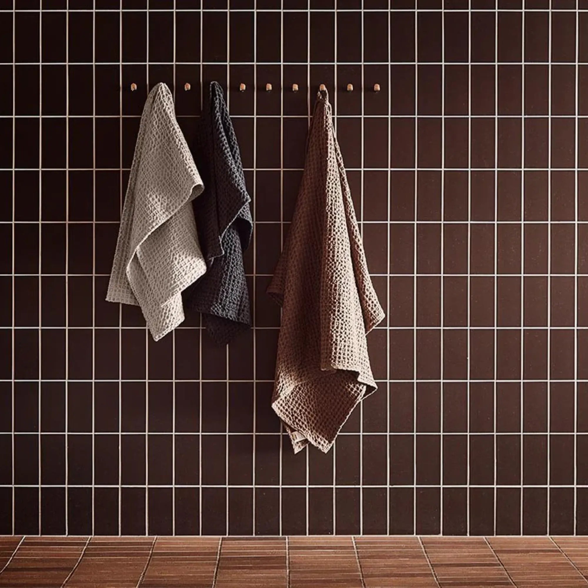 Puro Towel Set hanging on a stylish towel rack, adding a touch of sophistication and functionality to the bathroom decor