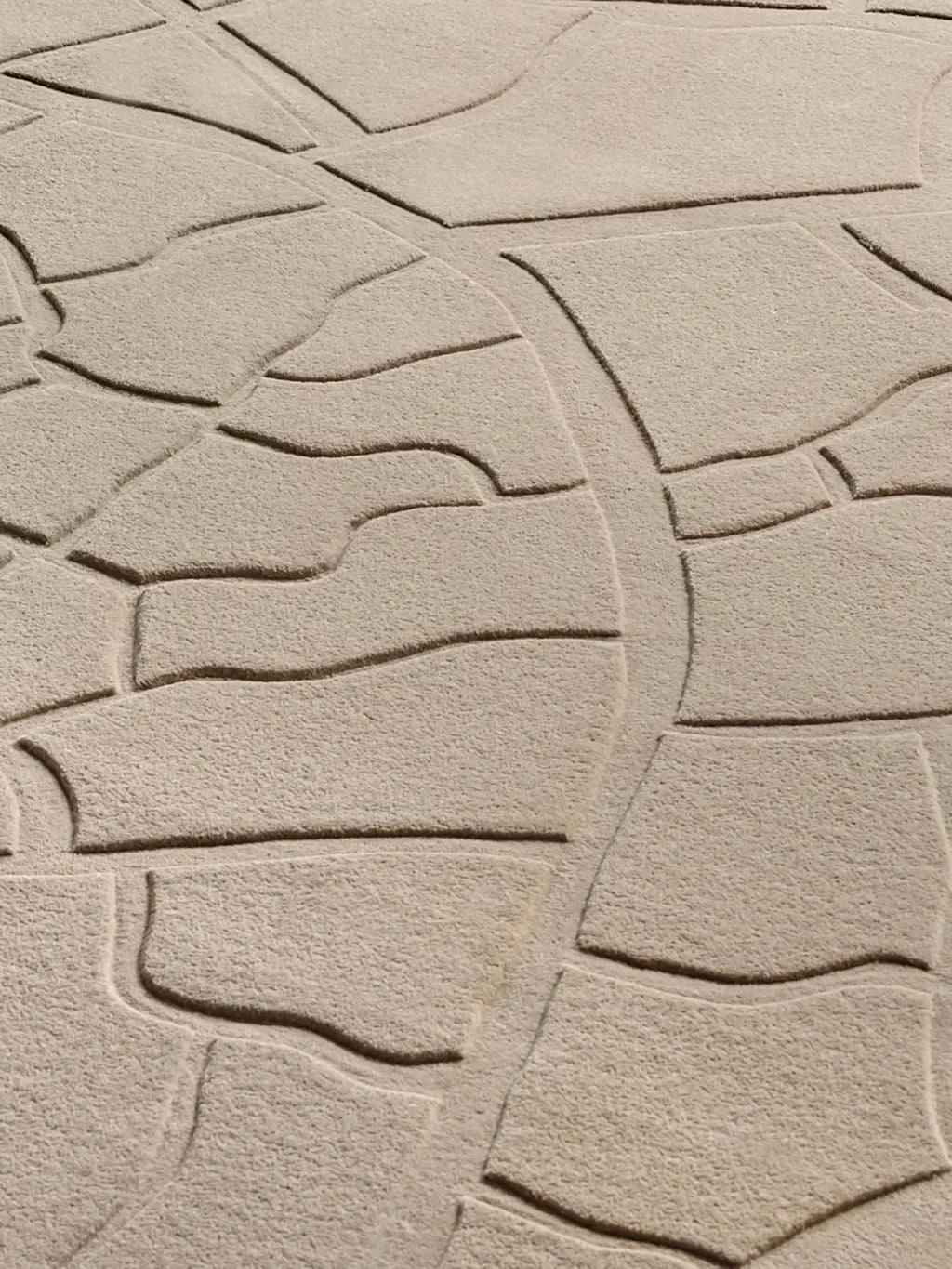 alp_ Aride I Rug, a contemporary abstract area rug in a natural sand beige tone, featuring a deeply carved high-low pile that creates an organic, topographic map-like pattern. This hand-tufted wool rug offers a plush textured surface and a minimalist design. Ideal for adding an organic modern touch to living rooms, bedrooms, or sophisticated dining spaces.