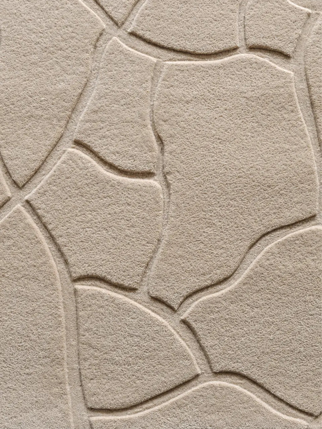 alp_ Aride I Rug, a neutral beige textured area rug featuring a carved organic pebble pattern with a plush, soft pile and subtle tonal variations. This contemporary wool blend rug showcases a distinctive embossed design, creating a natural, inviting feel. Perfect for organic modern living rooms, minimalist bedrooms, or cozy Scandinavian interiors seeking a sophisticated textured accent.