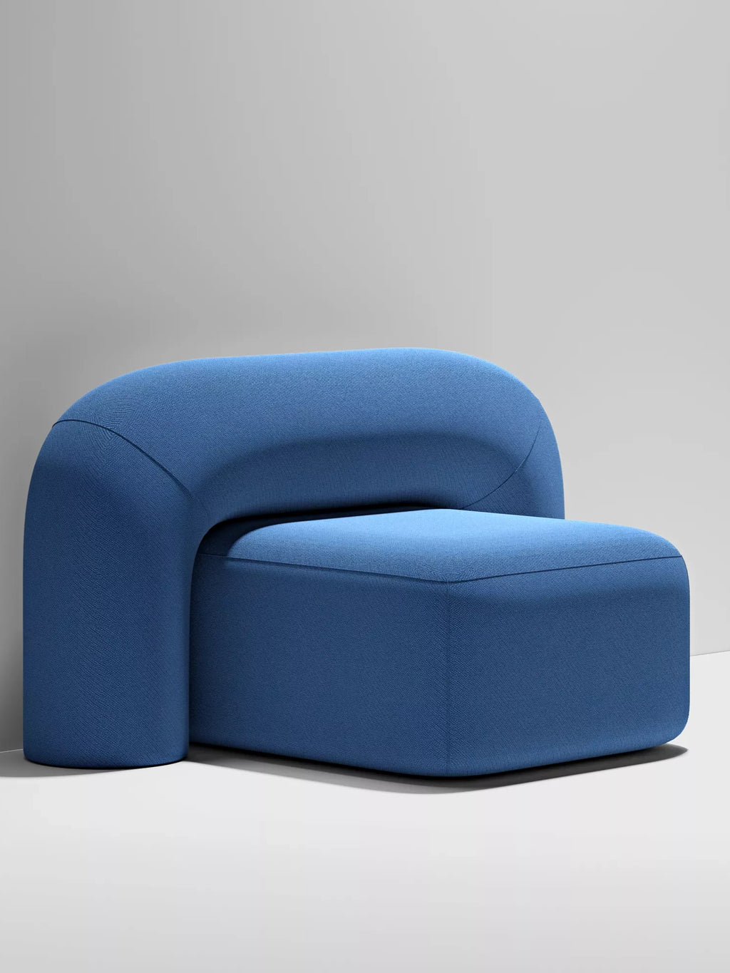 ARTU Moss Lounge Chair, a contemporary modular lounge chair upholstered in a vibrant deep royal blue fabric, featuring a distinctive U-shaped curved backrest and a clean rectangular seat. This sculptural accent chair has an organic modern design with smooth, minimalist lines. Perfect for a stylish living room, bedroom accent, or a cozy reading nook in modern interiors.